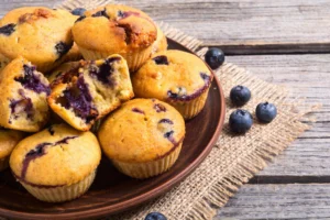 Freshly baked blueberry cheesecake muffins topped with blueberries