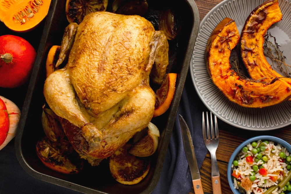 Finished baked whole chicken with rice in a serving dish