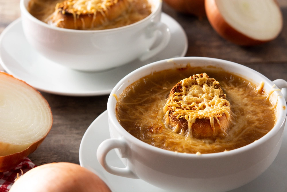 A bowl of famous Barr onion soup topped with melted cheese and crusty bread