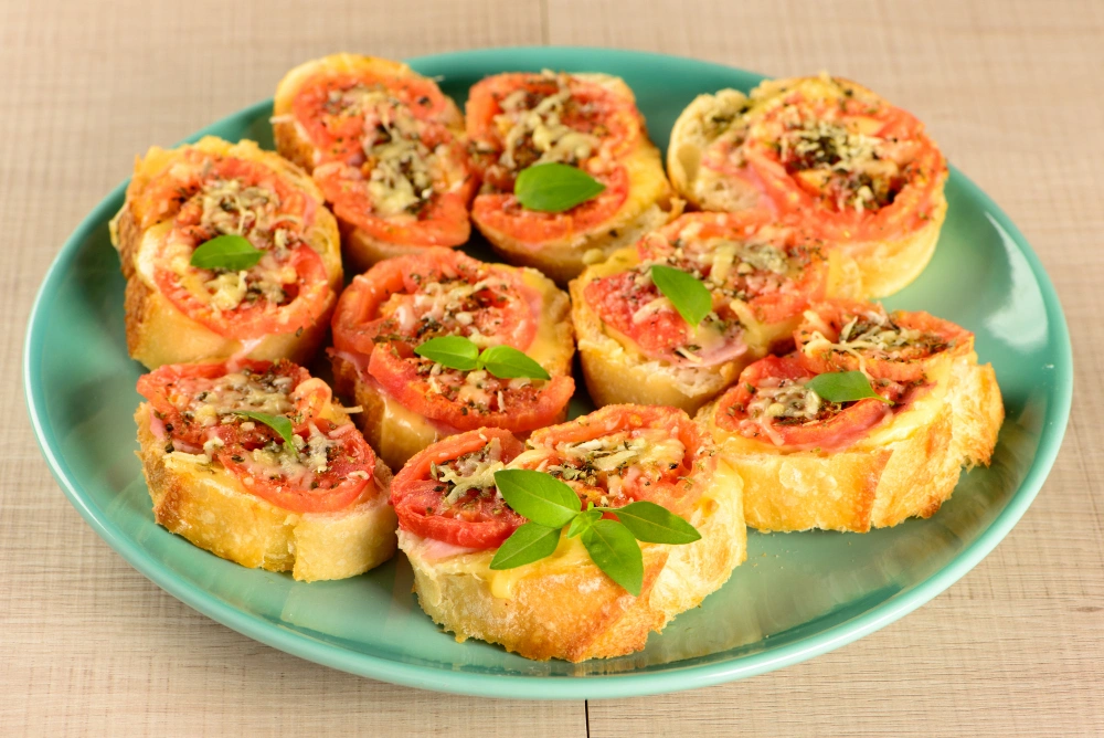 A plate of golden-brown breakfast pizza rolls filled with cheese, and eggs, for a beautiful breakfast