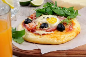 Golden crust gluten free breakfast pizza with a variety of toppings, ready to be served