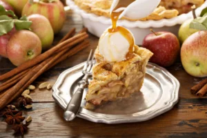 A delicious slice of apple pie on a rustic wooden table, highlighting its flaky crust and warm apple filling.