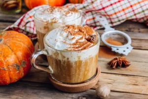 Delicious pumpkin chai latte, showcasing the warm colors of autumn with a sprinkle of cinnamon on top.