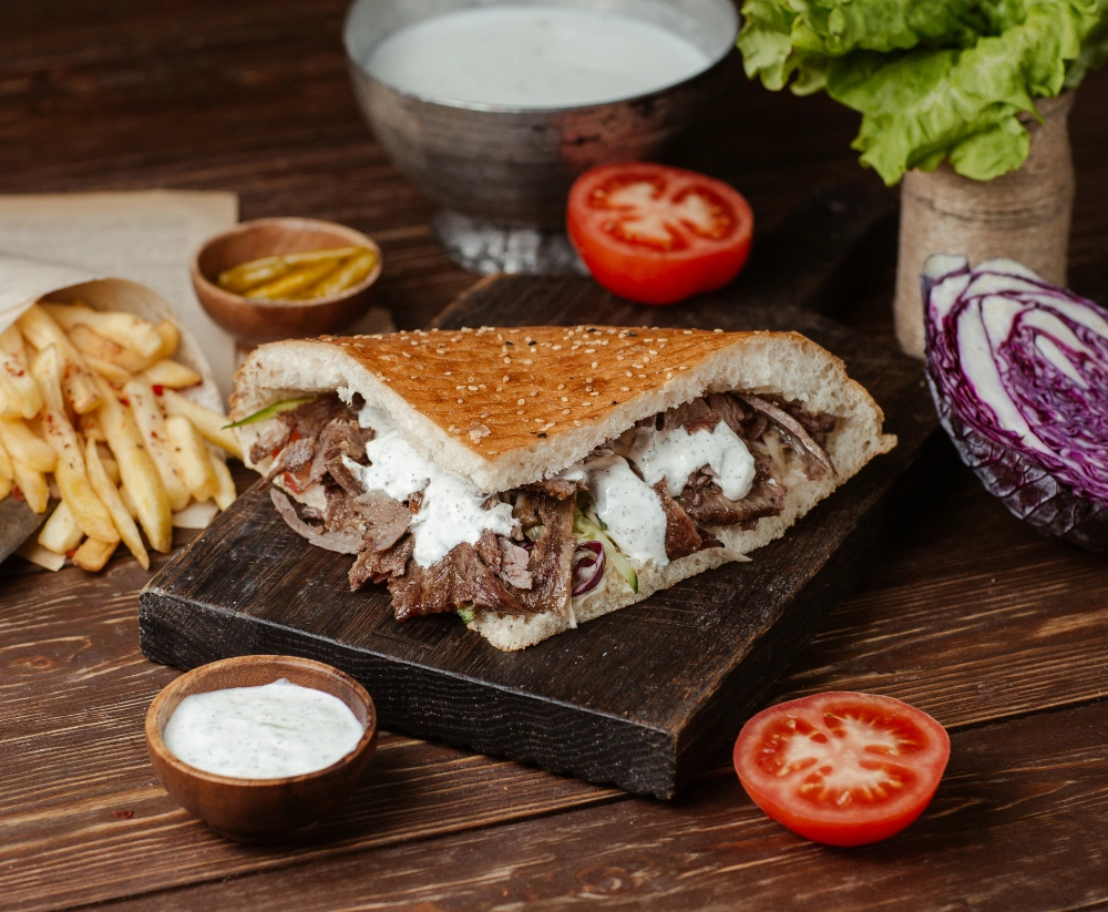 Sandwiche Lahme: Recipes, Tips, and Flavorful Variations 6 Chef assembling a Sandwiche Lahme with marinated meat and toppings.