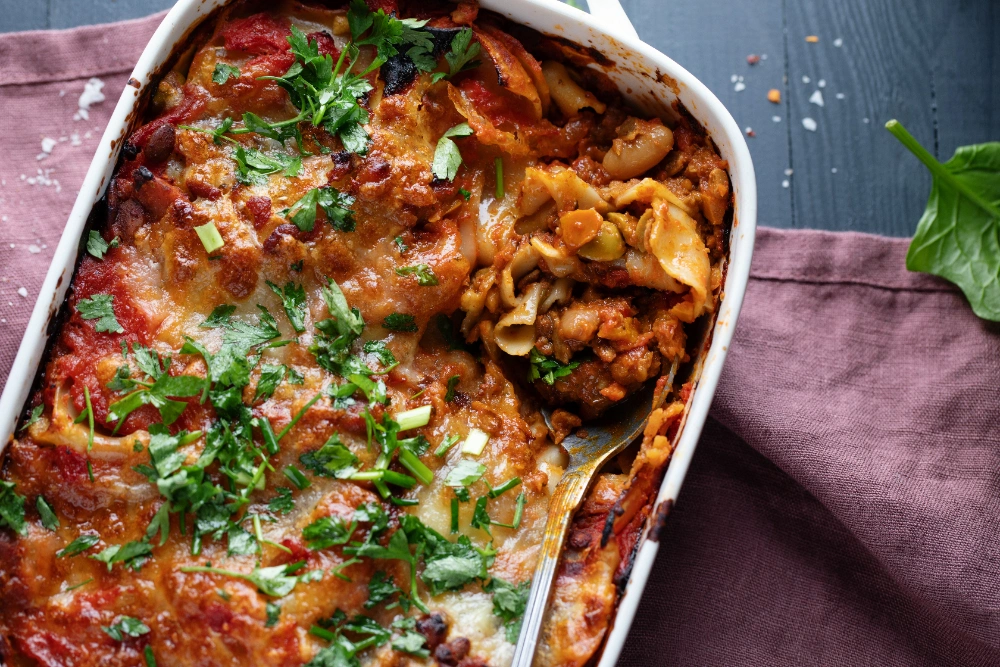 A freshly baked chicken and broccoli lasagna, bubbling with melted cheese and topped with golden-brown crust.