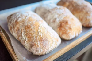 Freshly baked ciabatta rolls with a crispy crust and airy crumb.