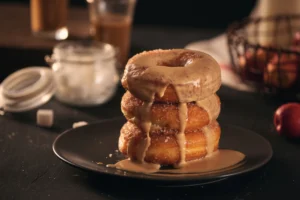 Delicious homemade donuts made with pancake mix, topped with chocolate glaze and colorful sprinkles, displayed on a rustic wooden table