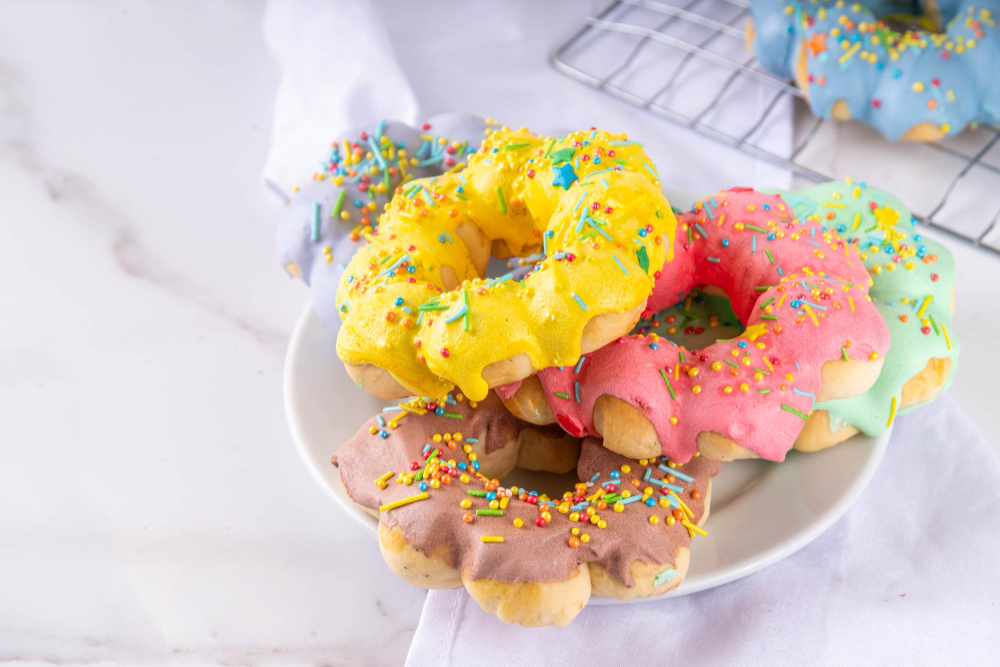 An image showcasing a variety of colorful mochi donuts arranged on a platter.