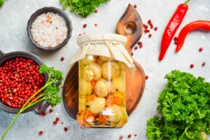 A jar of vibrant spicy pickled eggs, showcasing their rich color and garnished with spices