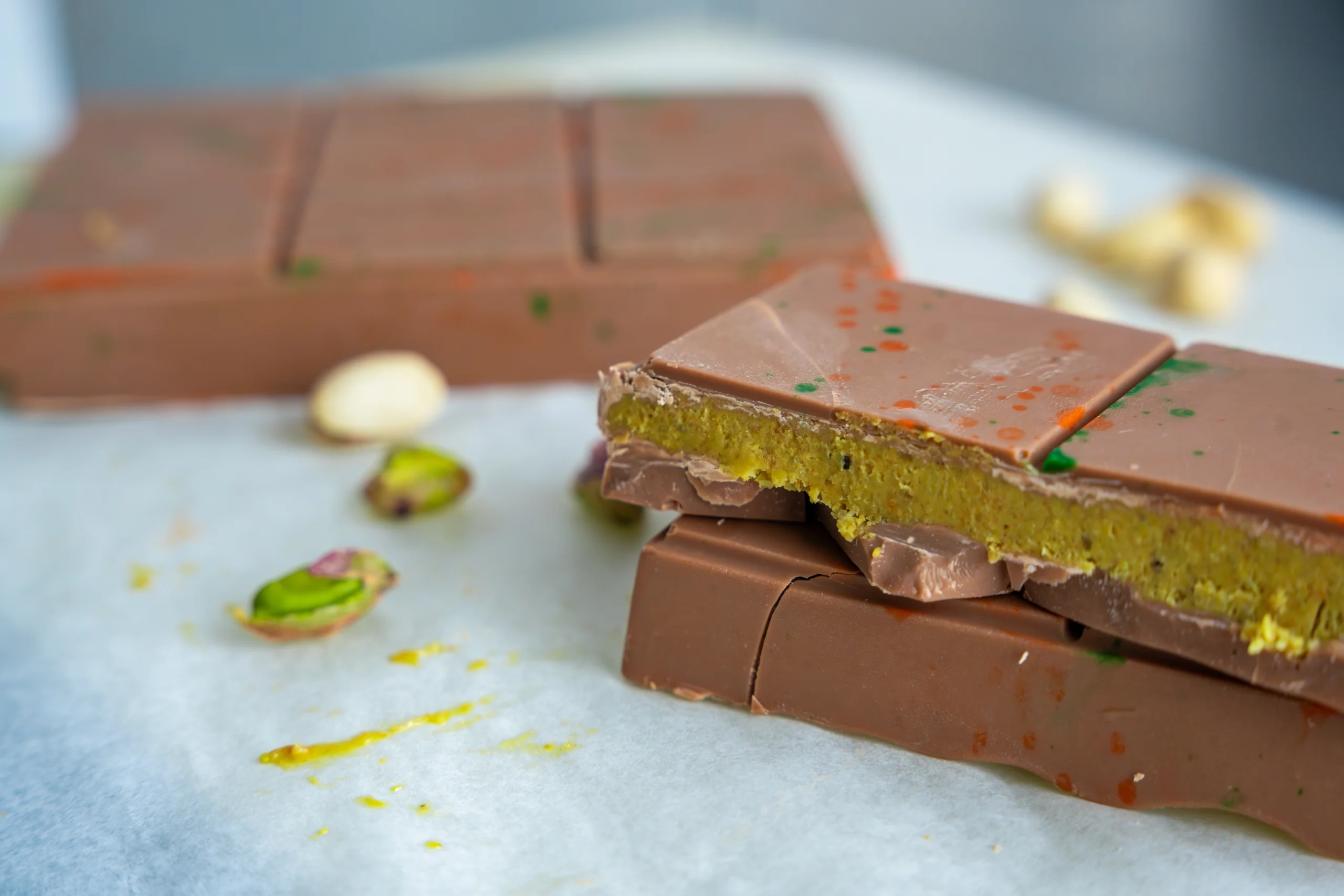 Close-up of luxurious Dubai chocolate bar with pistachios and kunafa.