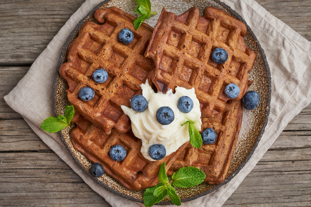 Delicious vegan protein waffles stacked on a plate, showcasing a nutritious and appealing breakfast option.