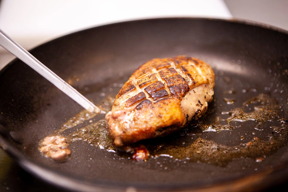 Delicious Blackened Chicken Caesar Salad Recipe & Tips 4 Blackened chicken breasts sizzling in a skillet