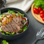 Finished steak Caesar salad in a bowl