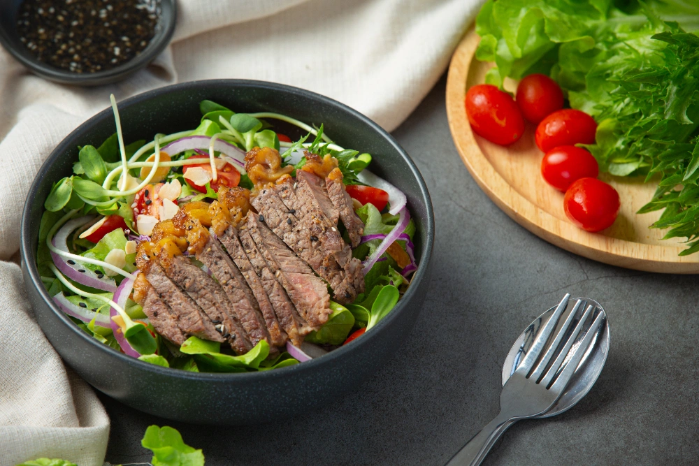 Finished steak Caesar salad in a bowl